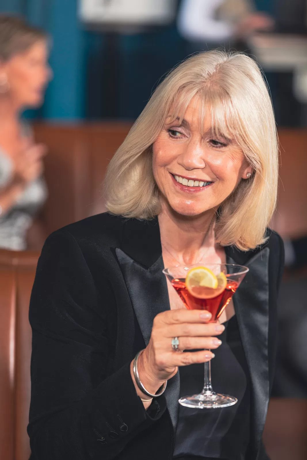 Saga cruise cocktail-bar photography — portrait of a woman in evening wear holding a cocktail