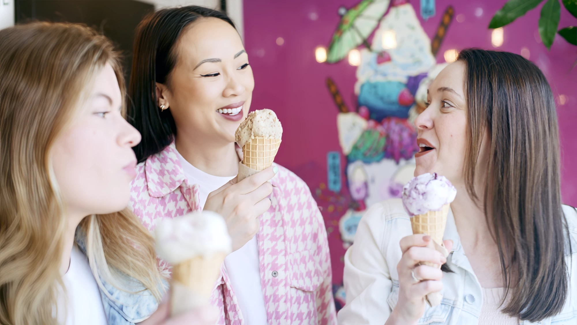Visit Kent tourism photography — friends sharing ice creams in front of a colourful seafront mural