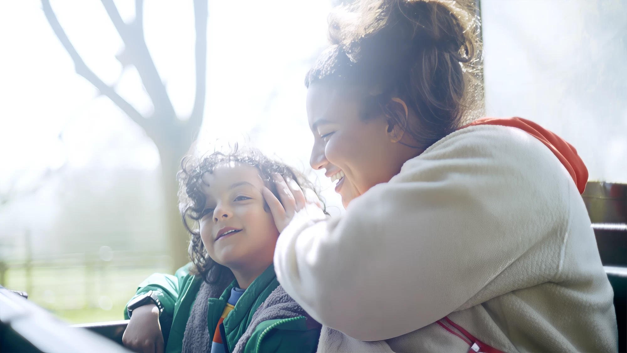 Visit Kent tourism photography — parent playfully ruffling child's hair by a sunlit window