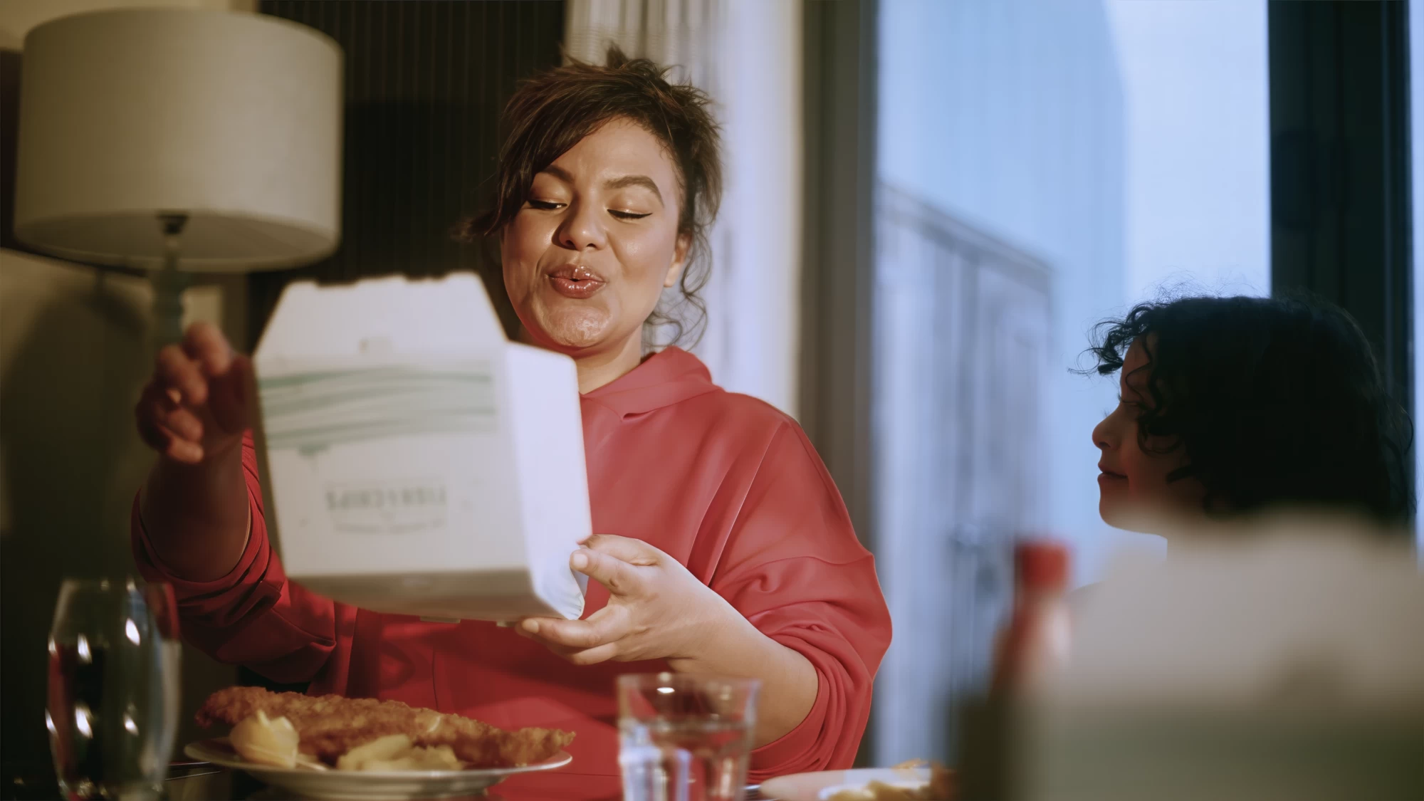 Visit Kent tourism photography — parent sharing a takeaway meal with child at the dinner table