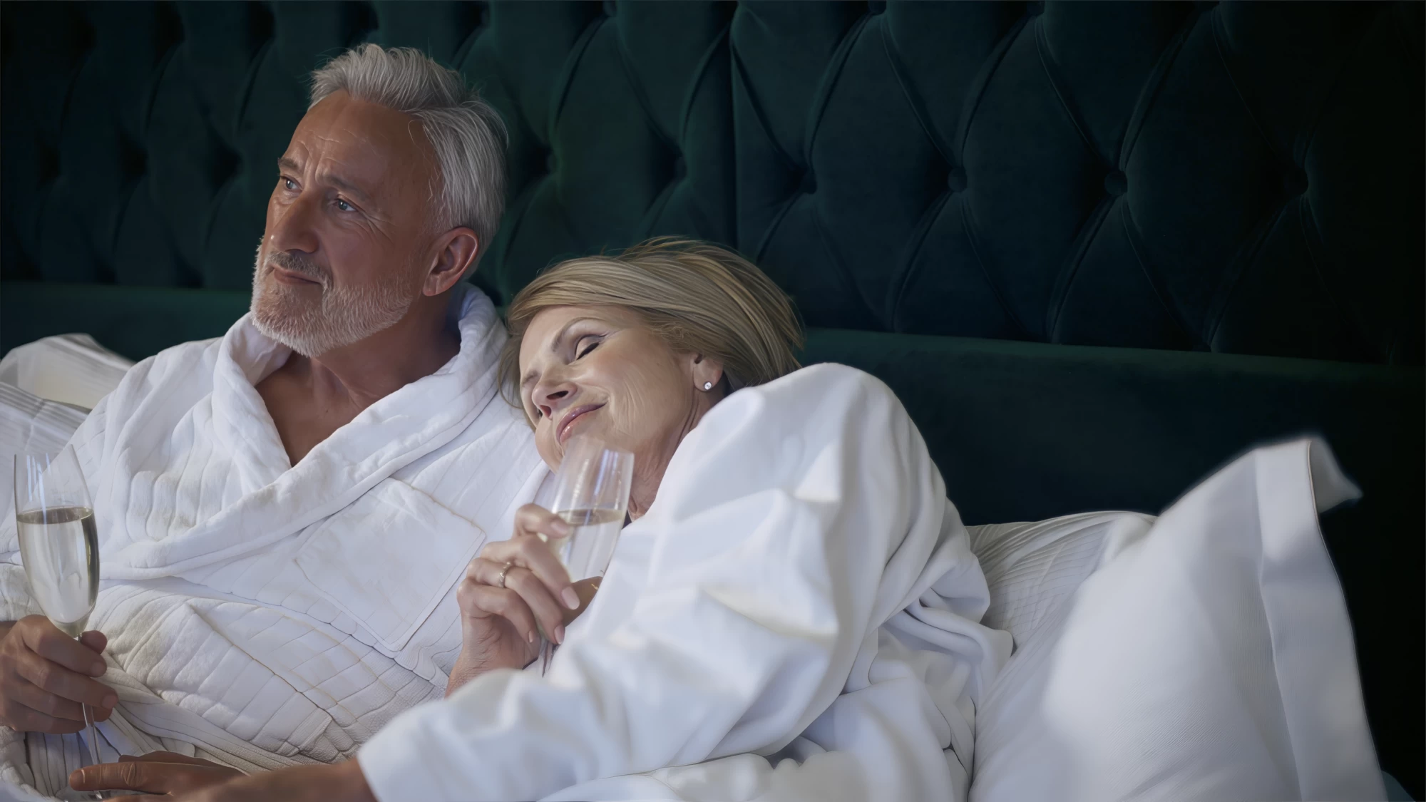 Visit Kent tourism photography — empty-nester couple relaxing in robes with champagne
